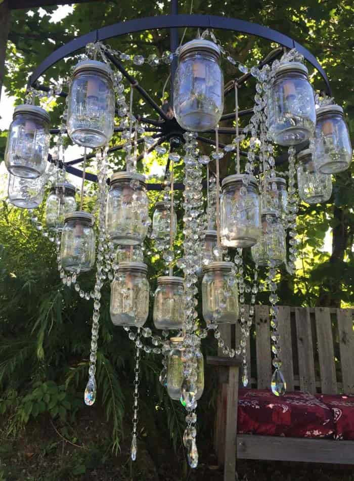 DIY Wagon Wheel Chandelier With Mason Jars and Crystal