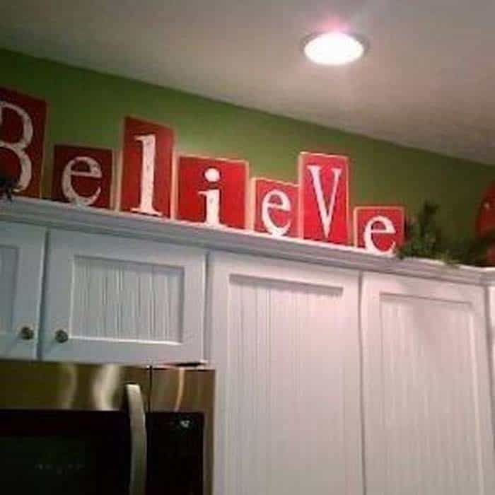 Adorn Kitchen Cabinets with a Wooden Believe Sign