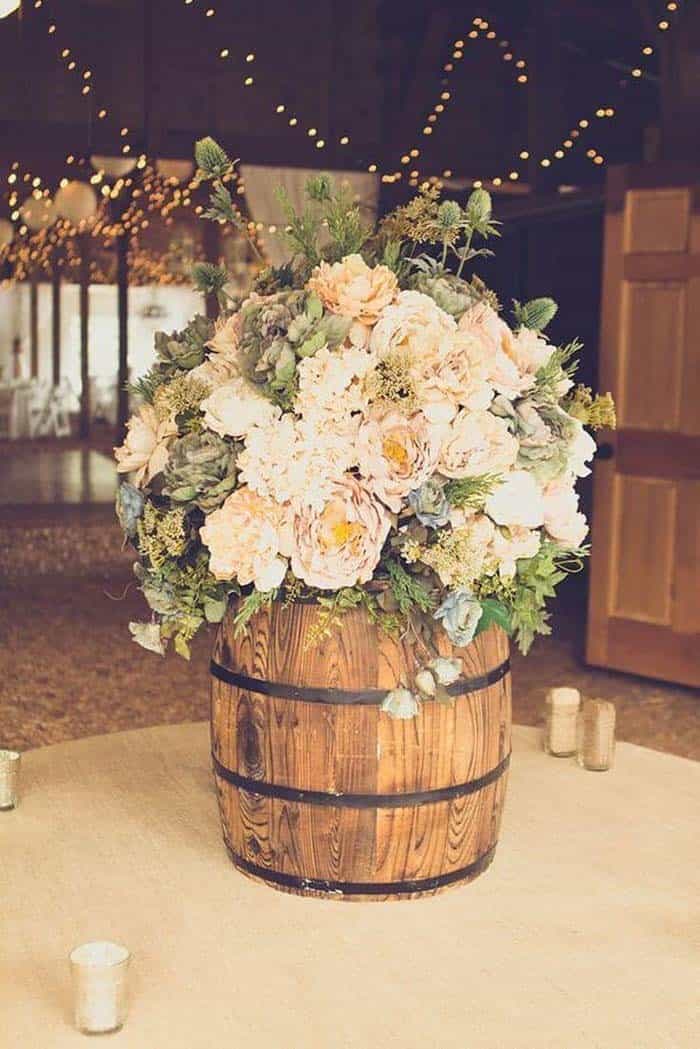 Cream Colored Flowers Fill a Rustic Barrel