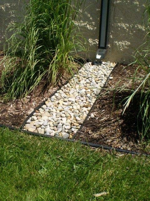 Redirect Your Drainage Pipe Water with Elegant White Rocks