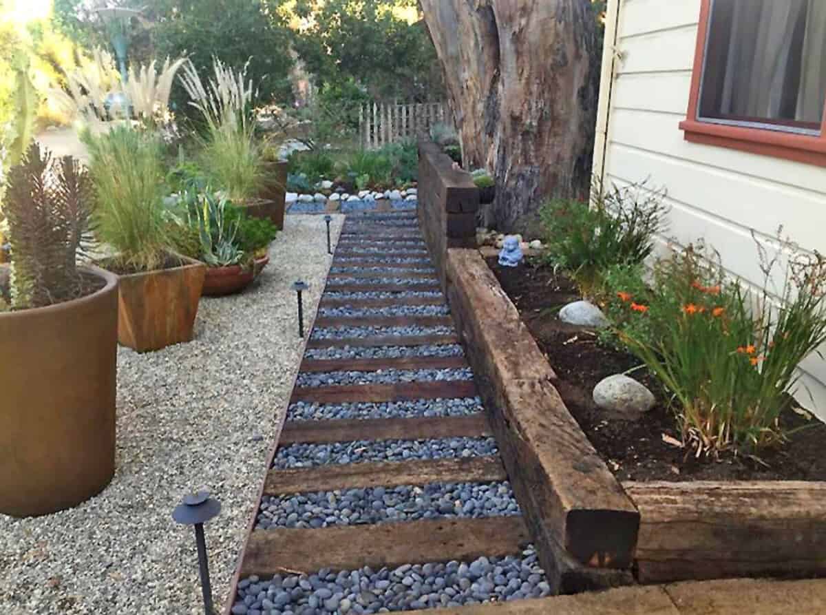 Grey Rocks With Wooden Beams For A Unique Walkway