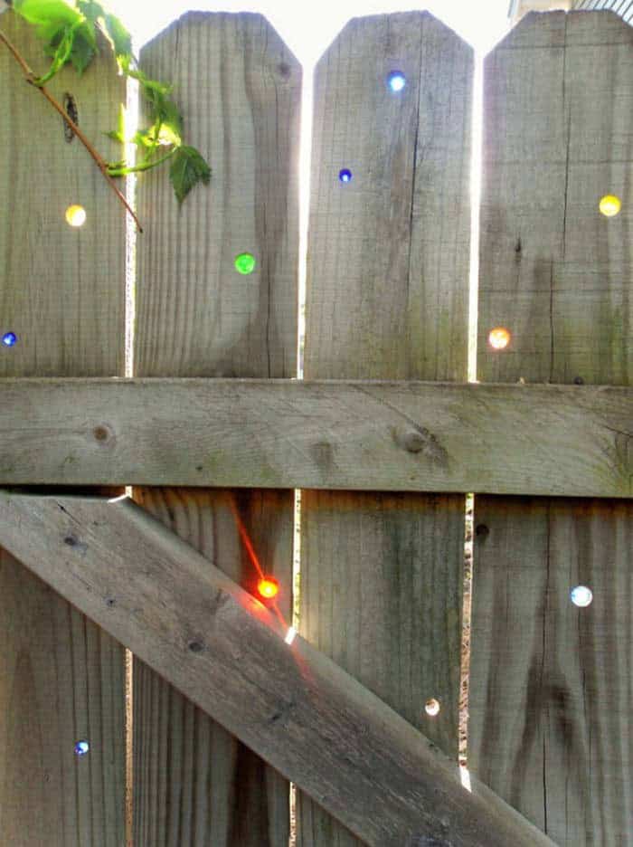 Colored Glass Makes Art Of Fence Holes