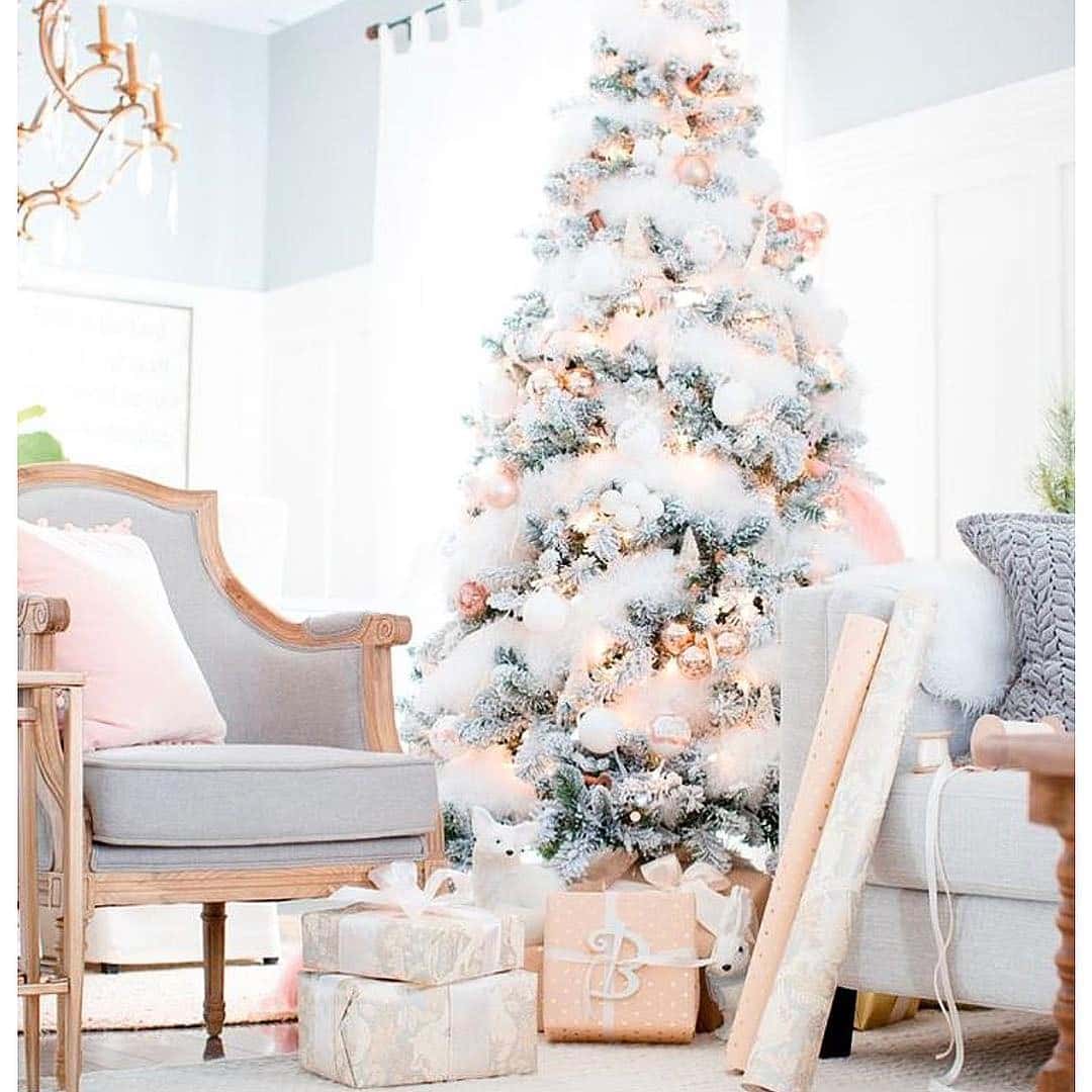 Rose Gold Ornaments On A Snowy Christmas Tree