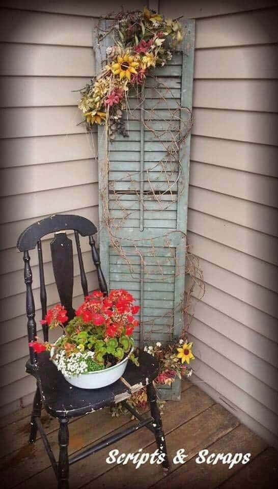 Distressed Chair And Shutter With Flowers