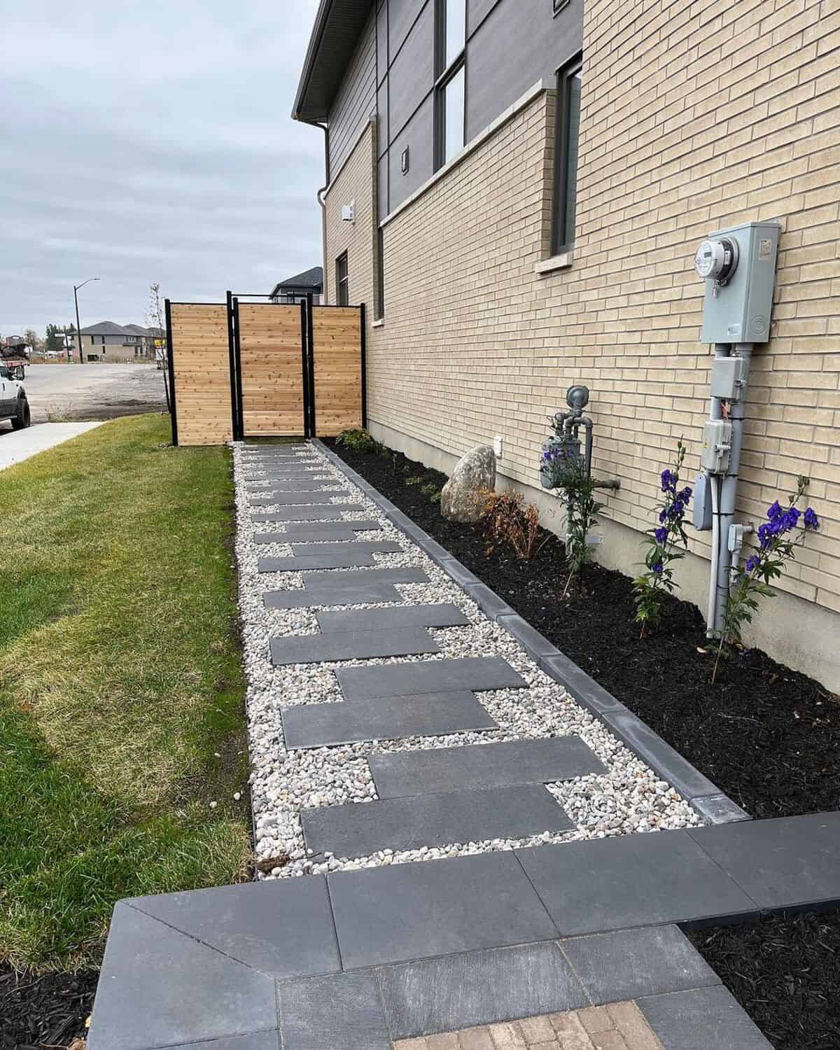 A Walkway With River Rocks And Tile Stepping Stones