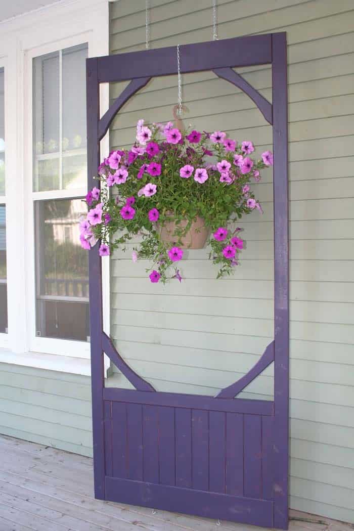 Frame Your Flowers With An Old Screen Door