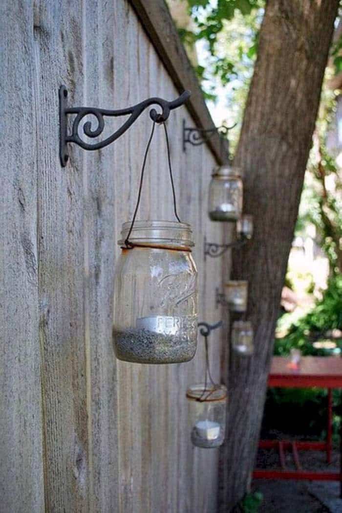 Illuminate Your Fence With Mason Jar Candle Holders