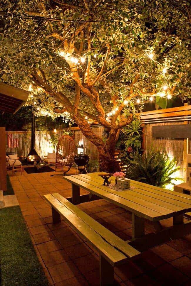 Tree-Hung String Lights Add Ambience To A Seating Area