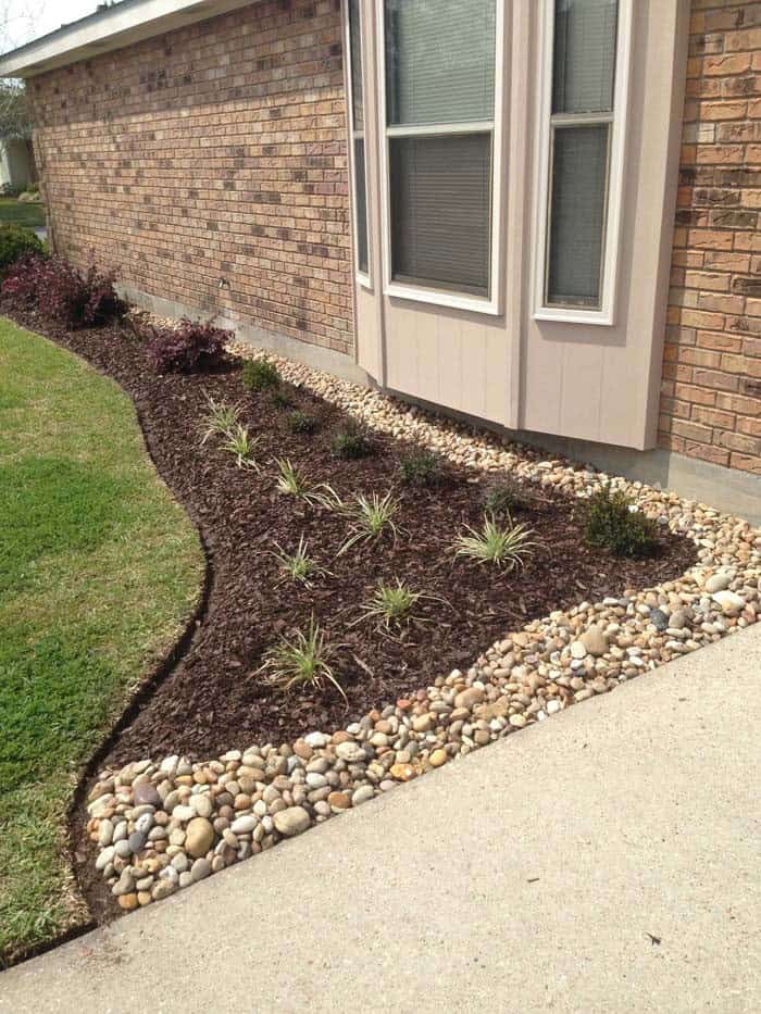 Separate Black Mulch with Pavement with River Rocks