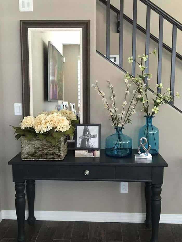 Elevate Your Entryway with a Framed Mirror and Vintage Table