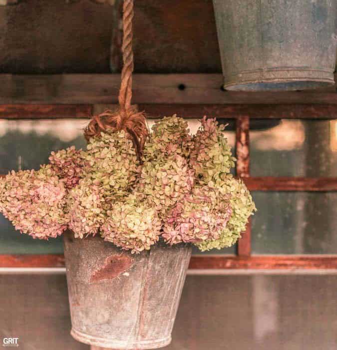 Make Garden Decor with Old Pulleys and Metal Buckets