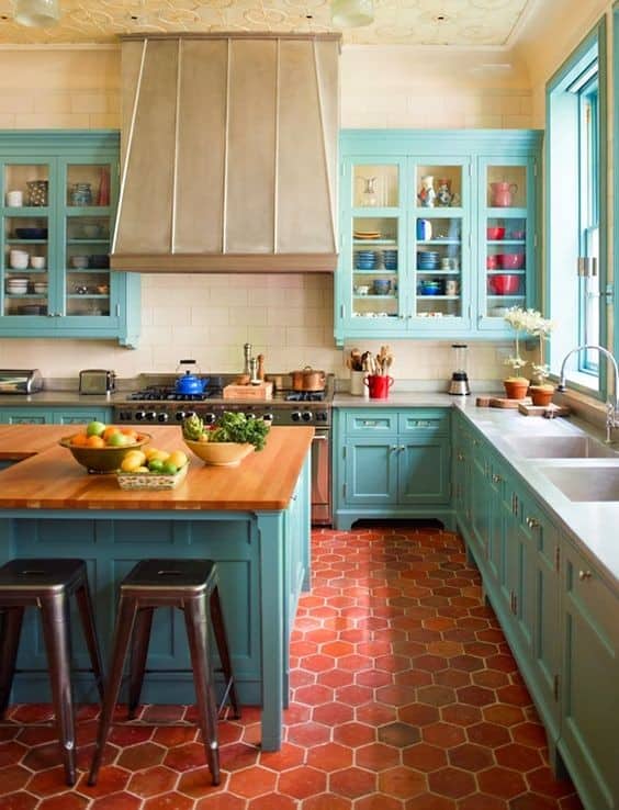 Get Farmhouse Charm with Red Brick Floor and Blue Cabinets