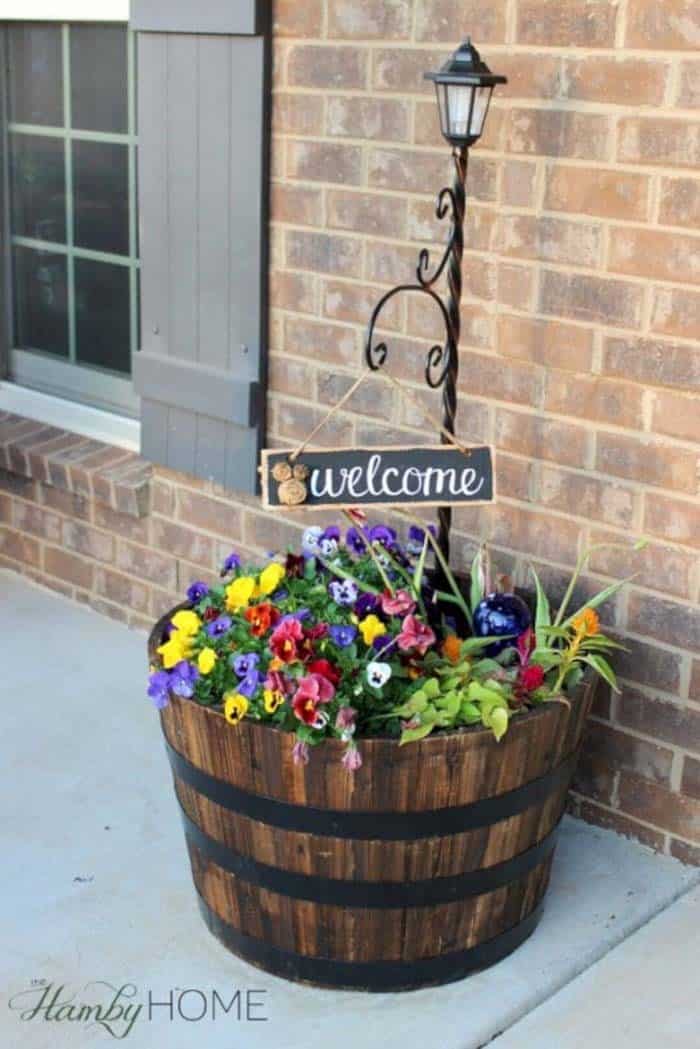 A Barrel Planter Brings Flowers To The Porch