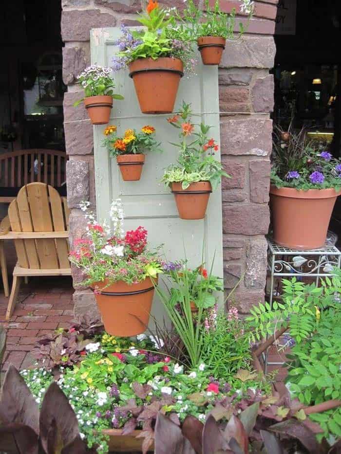 Vertical Flowerpots On An Old Door