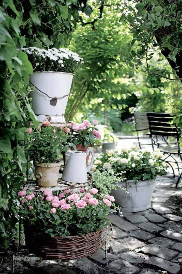 Watering Containers Repurposed Into Flower Pots