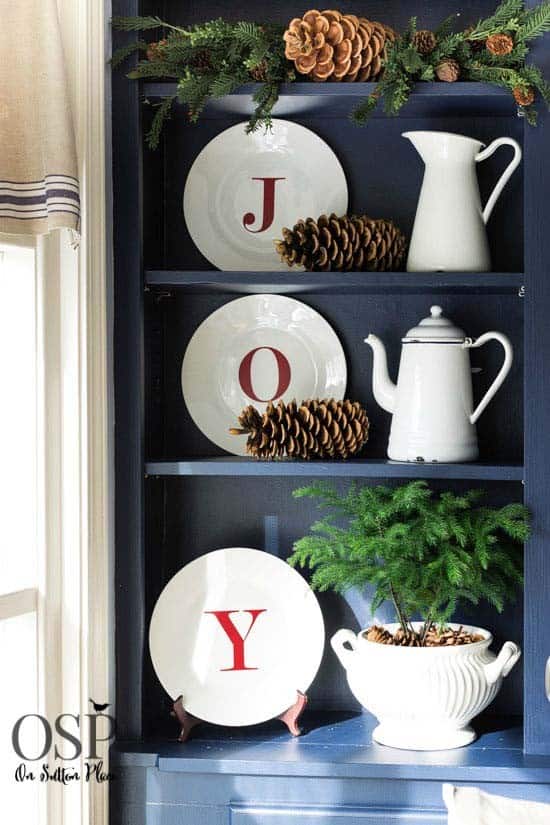 Arrange Plates and Pine Cones for a Rustic Joy Sign