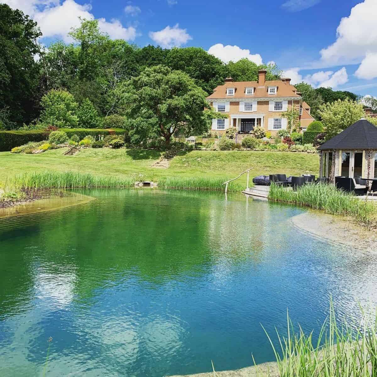 Natural Swimming Pond With A Deck And A Gazebo