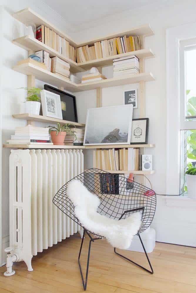 Pale Corner Shelves Define a Reading Nook in a Living Room