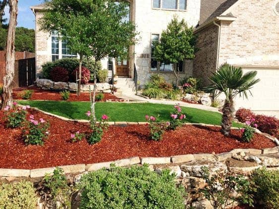 Use Red Mulch on Garden’s Retaining Wall