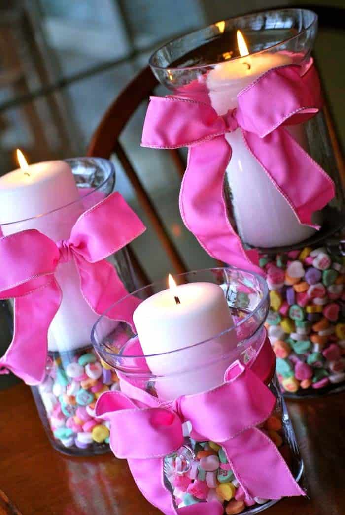 Utilize Candy-Filled Hurricane Vases as Candle Holders