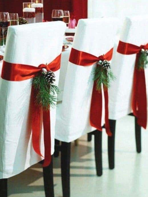 Upgrade White Chairs with Red Ribbon and Pinecones