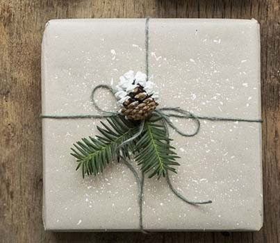 Paint-Splattered Brown Paper with Evergreen and Pinecone