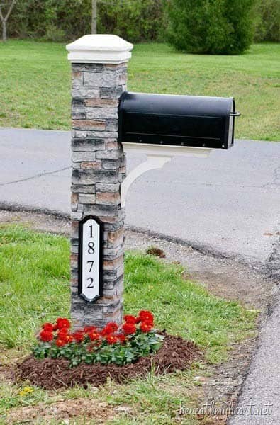 Mailbox And A House Number Sign On A Stone Post