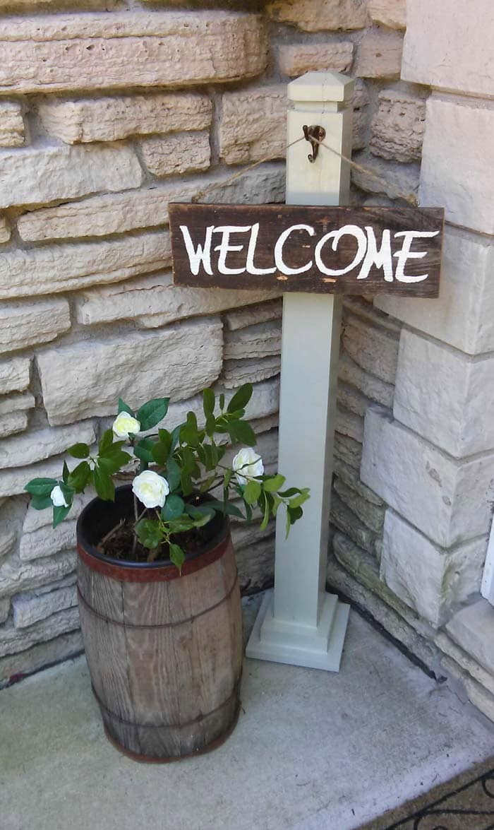 Welcome Sign with Rustic Floral Arrangement at the Porch