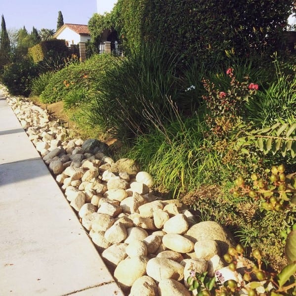 Border Your Fence with Light-Colored Garden Stones