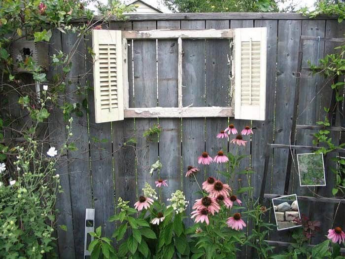 Transform Your Fence with a Repurposed Shutter Window